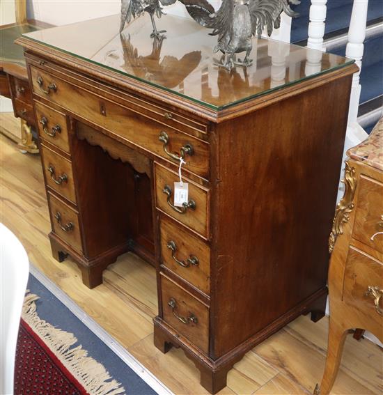 A George III mahogany kneehole desk with brushing slide W.96cm